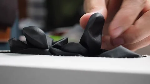 Macro shot female hand pulling black latex glove from white box. Hygiene Stock Footage 279305479