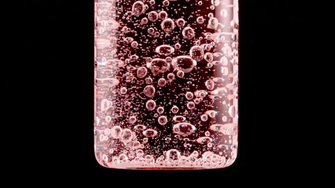 Macro shot of fine air bubbles rising in water in glass test tube on black Stock Footage 261028045