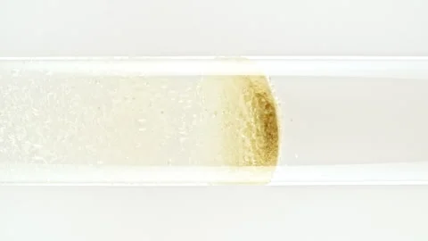 Macro shot of fine air bubbles rising in water in glass test tube on black Stock Footage 274148803
