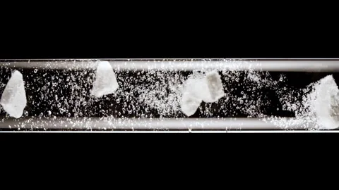 Macro shot of fine air bubbles rising in water in glass test tube on black Stock Footage 276992824