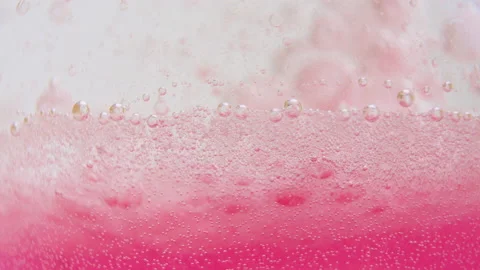 Macro shot of fine bubbles rising, In A glass with pink Liquid, slow motion Stock Footage 131103717