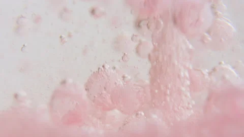 Macro shot of fine bubbles rising, In A glass with pink Liquid, slow motion Stock Footage 131104562