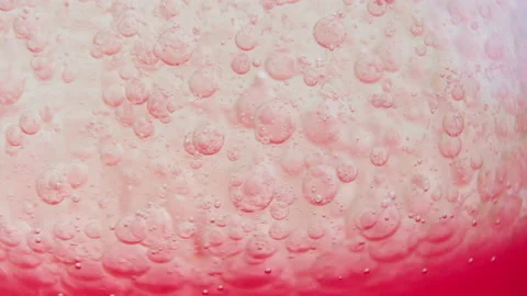 Macro shot of fine bubbles rising, In A glass with pink Liquid, slow motion Stock Footage 131105214