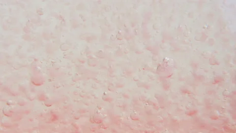 Macro shot of fine bubbles rising, In A glass with pink Liquid, slow motion Stock Footage 131106940