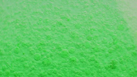 Macro shot of fine bubbles rising, In A glass with green Liquid, slow motion Stock Footage 131108374