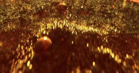 Macro Shot Of Fine Bubbles Rising In A Glass With Orange Liquid Stock Footage 146160834