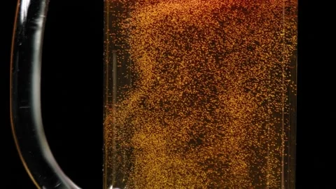 Macro Shot Of Fine Bubbles Rising In A Glass With Orange Liquid Stock Footage 159978158