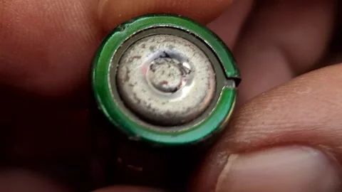 Macro Shot of Finger Holding Corroded Battery Terminal Stock Footage 310364978