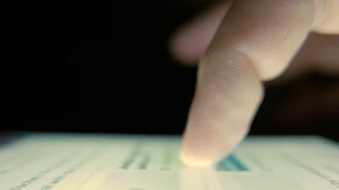 Macro Shot. Finger scrolls text on smartphone screen Stock Footage 100009907
