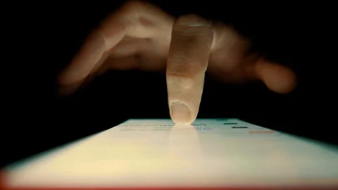 Macro Shot. Finger scrolls text on smartphone screen Stock Footage 100023376