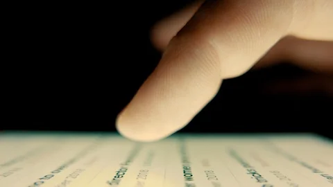 Macro Shot. Finger scrolls text on smartphone screen Stock Footage 100023723