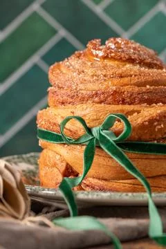 Macro shot of a flaky puff pastry Easter bread coated in sparkling cinnamon.. Stock Photos