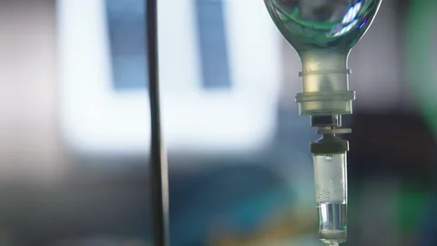 Macro shot of fluid dropping in an Intravenous (IV) tube in operation theatre Stock Footage 233964243