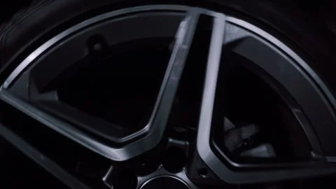 Macro shot footage of a beautifully rotating car wheel on chrome forged rims. Stock Footage 340580979