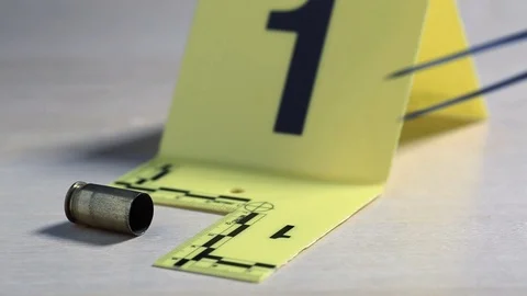Macro shot of forensic csi police officer collecting bullet casing as evidenc Stock Footage 119202588