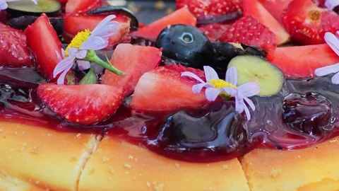 Macro shot of fresh berry toppings and glossy fruit sauce on a dessert. 스톡 동영상 339780784