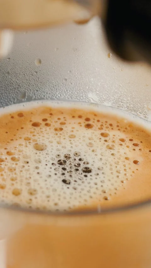 Macro Shot of Fresh Coffee Crema and Bubbles in Glass Cup Stock Footage 341668748