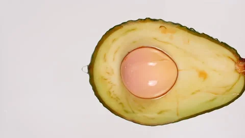 Macro Shot of Fresh cut Avocado with Juice and Oil Stream on White Background Stock Footage 161078905