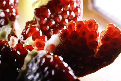 Macro Shot of Fresh Ruby-Red Pomegranate Seeds in Natural Light 写真素材