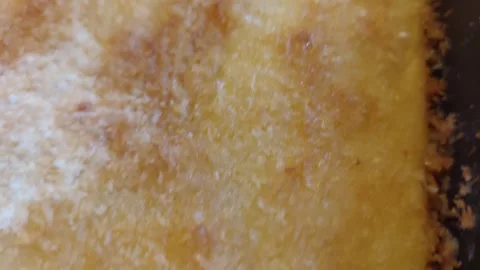 Macro Shot of Freshly Baked Cake Surface Sprinkled with Coconut Vídeos de archivo 333642387