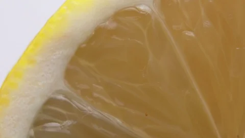 Macro shot of freshly sliced Lemon. Bright Yellow Lemon segments and thin skin Stock Footage 126635951