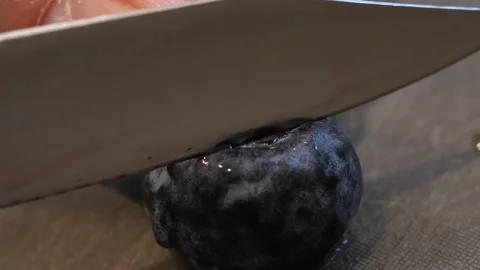 Macro shot of fruit being cut down the center Stock Footage 258095910