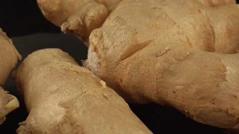 Macro shot of ginger root on the black background. Aromatic spices. Light brown Stock Footage 165282397