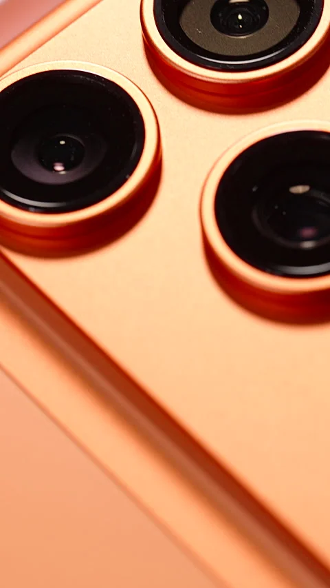 Macro Shot of Glossy Apple Logo on Back of Cosmic Orange iPhone 17 Pro with Stock Footage 318057276