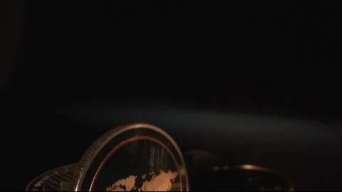 Macro shot of gold digital crypto coin Ripple from Laowa 24 Probe lens. Black Stock Footage 132489381