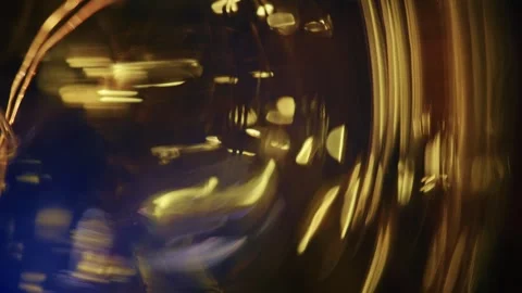 Macro Shot of Golden Light Streaks and Glass Refraction Stock Footage 346757042