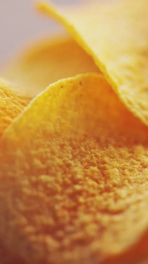 Macro Shot of Golden Potato Chip with Bokeh Background Vertical Video Stock Footage 314598155