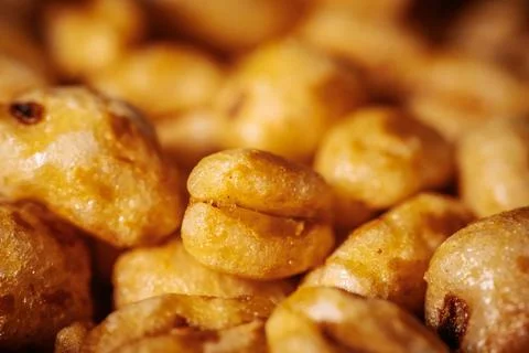 A macro shot of golden puffed cereal pieces with a shiny. Stock Photos
