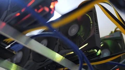 Macro shot of graphic cards mining cryptocurrency on a rig, with cables in fo Stock Photos