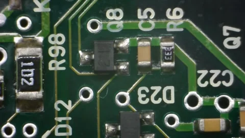 A macro shot of a green circuit board with a translucent glue drop Stock Footage 336710934