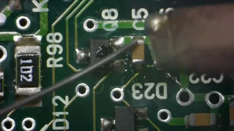 A macro shot of a green circuit board with a translucent glue drop Stock Footage 336710951
