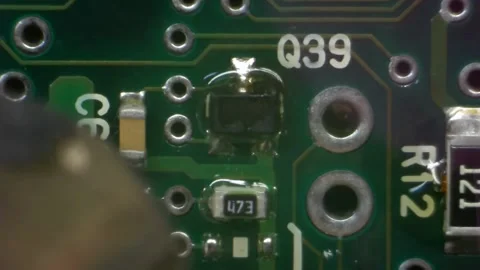 A macro shot of a green circuit board with a translucent glue drop Stock Footage 336711000