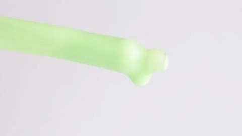 Macro shot of green moisturizing serum lotion falling from a glass pipette Stock Footage 272600106