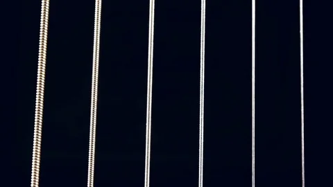 Macro shot of guitar strings vibrating 스톡 동영상 72236959