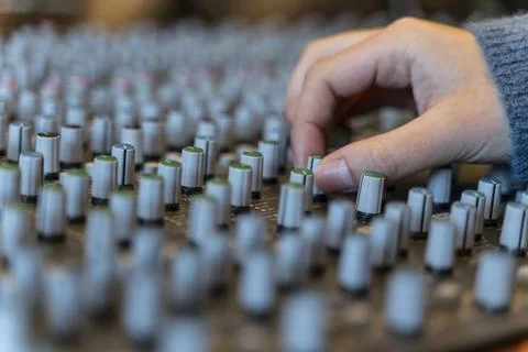 Macro shot of a hand in a control panel of a music recording studio Stock Photos