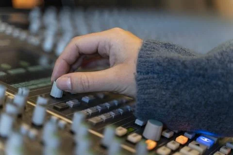 Macro shot of a hand in a control panel of a music recording studio Stock Photos