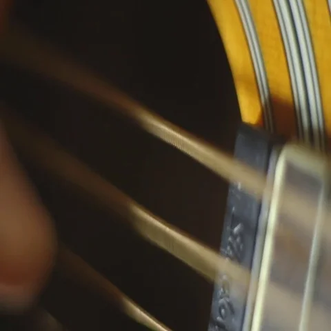 Macro shot of hand picking and strumming guitar Stock Footage