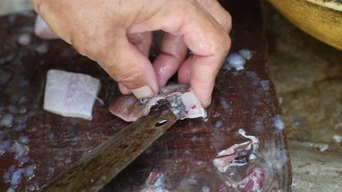 Macro shot on hands cutting and cleaning fresh fish on a wooden board. Stock Footage 139326178