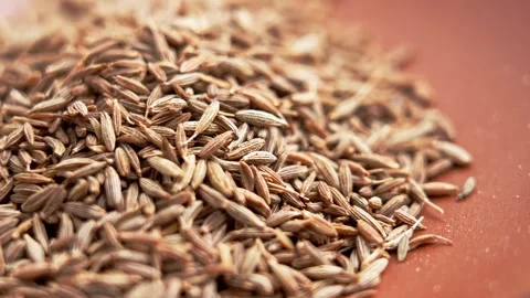 Macro shot of a heap of whole dried cumin seeds Video stock 336077451