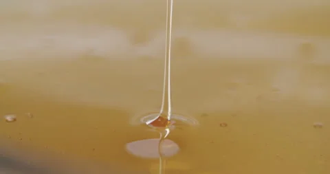 Macro shot of honey getting poured Stock Footage