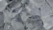 Macro Shot Of Ice Cubes On A Turning Table With Flickering Green Light Stock Footage