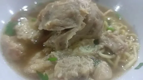 Macro shot of Indonesian beef meatball soup Bakso with rich savory broth Stock Footage 339050563