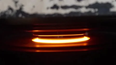 Macro shot of an industrial press striking a glowing hot metal component Stock Footage 332917896