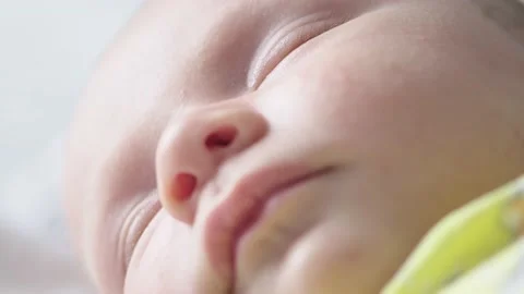 Macro shot of infants hand, and face.  Slow motion Video of kids hand. Macro Stock Footage 160168360