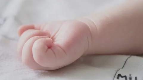 Macro shot of infants hand.  Slow motion Video of kids hand. Macro cinematic Stock Footage 160168335