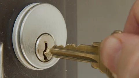 Macro shot of inserting key into a lock and unlocking a door Stock Footage 111963356